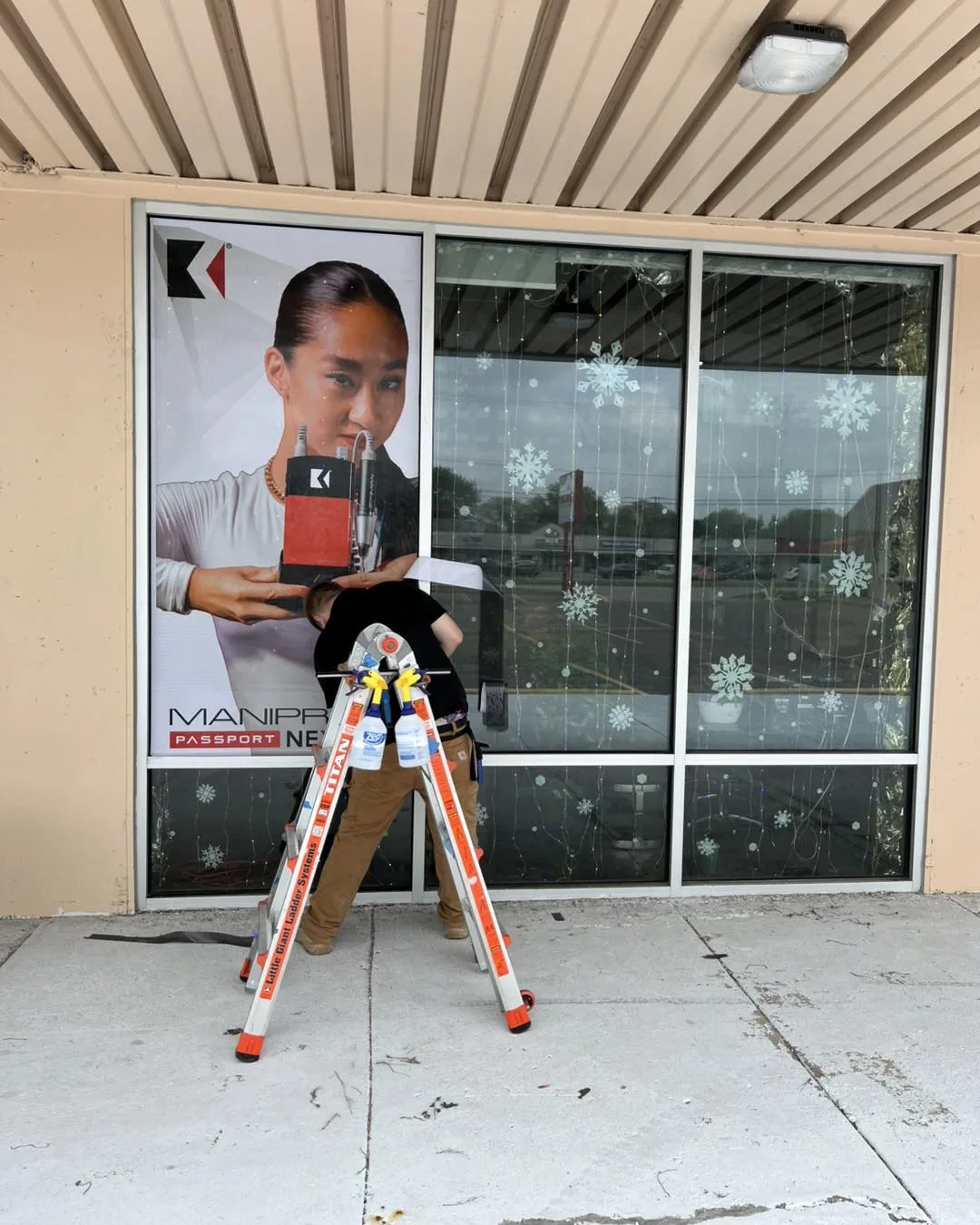 DLK Graphics fitting window graphics to a storefront